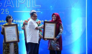 Mendagri Tito Karnavian menyerahkan Sertifikat ISO 27001 kepada Kepala Dinas Dukcapil Kota Tidore Kepulauan, Sunaryah Saripan dalam acara Rakornas Dukcapil 2025 di Jakarta, Rabu (23/4/2025).